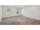 Large carpeted bedroom with natural light from two windows and neutral wall paint at 5618 Shadow Rock Dr, Lithonia, GA 30058