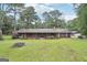 Charming single-story home featuring a welcoming porch, mature trees, and a spacious front yard at 5618 Shadow Rock Dr, Lithonia, GA 30058