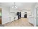 Well-lit kitchen with white cabinetry, black appliances, and a convenient workstation at 5618 Shadow Rock Dr, Lithonia, GA 30058