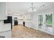 Bright kitchen features white cabinets, appliances, and a view to the yard at 5618 Shadow Rock Dr, Lithonia, GA 30058