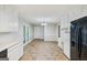 Spacious kitchen with white cabinets, black appliances, and adjacent dining area at 5618 Shadow Rock Dr, Lithonia, GA 30058