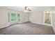 Spacious living room with new carpet, neutral paint, lots of natural light and access to the front door at 5618 Shadow Rock Dr, Lithonia, GA 30058