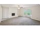 Bright living room boasts a fireplace, neutral walls, new carpet, and a bay window at 5618 Shadow Rock Dr, Lithonia, GA 30058