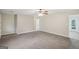 Clean and spacious living area with carpet, and neutral walls leading to a hallway and other rooms at 5618 Shadow Rock Dr, Lithonia, GA 30058