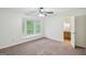 Bright carpeted main bedroom featuring a large window nook and an en-suite bathroom at 5618 Shadow Rock Dr, Lithonia, GA 30058