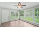 Inviting sun room with large windows and natural light, and ceiling fan at 5618 Shadow Rock Dr, Lithonia, GA 30058