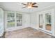 Sun room featuring neutral walls, tiled floor, multiple windows, and glass doors at 5618 Shadow Rock Dr, Lithonia, GA 30058