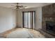 Living room with a stone fireplace, sliding glass doors and significant damage on floor at 5908 Trent Jones Way, Lithonia, GA 30038