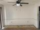 Empty living room featuring a ceiling fan and walls with some damage at 5908 Trent Jones Way, Lithonia, GA 30038