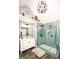 Beautiful bathroom featuring a glass shower, dual sinks, and modern lighting fixtures at 190 Country Club Dr, Hiram, GA 30141
