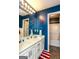 Navy blue bathroom with a double sink vanity, tile floors, and nautical decorations at 190 Country Club Dr, Hiram, GA 30141