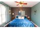 Comfortable bedroom with blue bedding, carpet floors, and a ceiling fan fixture at 190 Country Club Dr, Hiram, GA 30141