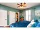 Cozy bedroom with ensuite bathroom, laminate floors, and a ceiling fan fixture at 190 Country Club Dr, Hiram, GA 30141