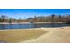 Golf course with a lake, a fountain, flags and putting green at 190 Country Club Dr, Hiram, GA 30141