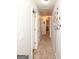 Long hallway with carpet floors, grey walls, white doors, and decorative tree wall art at 190 Country Club Dr, Hiram, GA 30141