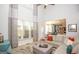 Bright open-concept living room featuring large windows, high ceilings, and seamless flow into the adjacent kitchen at 190 Country Club Dr, Hiram, GA 30141
