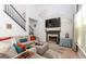 Bright living room with vaulted ceilings, a cozy fireplace, and a staircase leading to the upper level at 190 Country Club Dr, Hiram, GA 30141