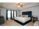 Cozy main bedroom with a tray ceiling, a ceiling fan, and large windows for ample natural light at 190 Country Club Dr, Hiram, GA 30141