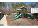 Community playground with swings, slides, and a wood chip ground cover at 190 Country Club Dr, Hiram, GA 30141