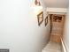 A staircase with carpet flooring, a white handrail, and decorative pictures on the wall at 190 Country Club Dr, Hiram, GA 30141