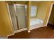 Bathroom with shower, tub and vinyl floors at 1472 Queenie Smith Ne Rd, Conyers, GA 30012