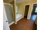Bathroom featuring a glass-enclosed shower and soaking tub with vinyl flooring at 1472 Queenie Smith Ne Rd, Conyers, GA 30012