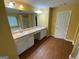 Well lit bathroom featuring double vanity, hardwood floors, bathtub, and stand-alone shower at 1472 Queenie Smith Ne Rd, Conyers, GA 30012