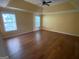 Large bedroom featuring tray ceilings, hardwood floors, and natural lighting at 1472 Queenie Smith Ne Rd, Conyers, GA 30012