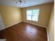 Bedroom featuring hardwood floors, a window, and a ceiling light fixture at 1472 Queenie Smith Ne Rd, Conyers, GA 30012