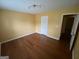 Bedroom with hardwood floors, yellow walls, and modern ceiling light fixture at 1472 Queenie Smith Ne Rd, Conyers, GA 30012