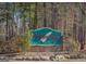 Stone signage marks the entrance to Cherokee Run Golf Club, nestled among towering trees and natural beauty at 1472 Queenie Smith Ne Rd, Conyers, GA 30012