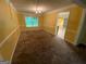 The well-lit dining room features classic wainscoting, plush carpeting, and an elegant chandelier at 1472 Queenie Smith Ne Rd, Conyers, GA 30012