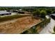 Aerial view of a horse arena with horses and riders, featuring well-maintained grounds and equestrian facilities at 1472 Queenie Smith Ne Rd, Conyers, GA 30012