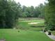 Beautiful golf course view featuring lush green fairways, sand traps, and players on the course at 1472 Queenie Smith Ne Rd, Conyers, GA 30012