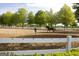 Horse training arena featuring a horse and trainer behind a white fence at 1472 Queenie Smith Ne Rd, Conyers, GA 30012