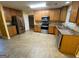 Spacious kitchen featuring stainless steel appliances, wooden cabinets, and tile flooring at 1472 Queenie Smith Ne Rd, Conyers, GA 30012