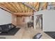 Spacious unfinished basement with exposed ceiling, black couch, and concrete flooring at 419 Jeffery Dr, Locust Grove, GA 30248