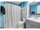 Bathroom featuring blue walls, patterned shower curtain, and white storage cabinet at 419 Jeffery Dr, Locust Grove, GA 30248