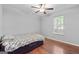 Bedroom with ceiling fan and wood floors, filled with natural light from the window at 419 Jeffery Dr, Locust Grove, GA 30248