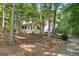Quaint single-Gathering home with a side view surrounded by lush, mature trees at 419 Jeffery Dr, Locust Grove, GA 30248