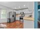 Bright kitchen with stainless steel appliances, white cabinetry, and wood-look flooring at 419 Jeffery Dr, Locust Grove, GA 30248