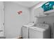 Functional laundry room with washer, dryer, and storage at 419 Jeffery Dr, Locust Grove, GA 30248