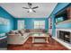 Cozy living room features a fireplace, plush sectional sofa, and wood floors at 419 Jeffery Dr, Locust Grove, GA 30248