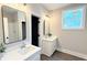 Bright bathroom with double sinks, large mirrors, and new fixtures offers a spa-like feel at 485 West Ave, Bowdon, GA 30108