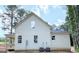 Exterior of the home with white siding and several windows, revealing the house's well-lit interior at 485 West Ave, Bowdon, GA 30108