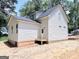 Rear view of the home with a small deck and clean white siding at 485 West Ave, Bowdon, GA 30108