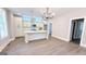 Open living space with modern light fixtures and kitchen area at 485 West Ave, Bowdon, GA 30108