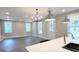 Spacious living area with modern light fixtures and a door to the exterior at 485 West Ave, Bowdon, GA 30108