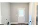 Mudroom with a full-light glass door and utility connections. Ideal for all your laundry needs at 485 West Ave, Bowdon, GA 30108