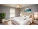 Cozy bedroom with a large window, ceiling fan, neutral decor and plush carpeting at 1252 Heritage Dr, Villa Rica, GA 30180